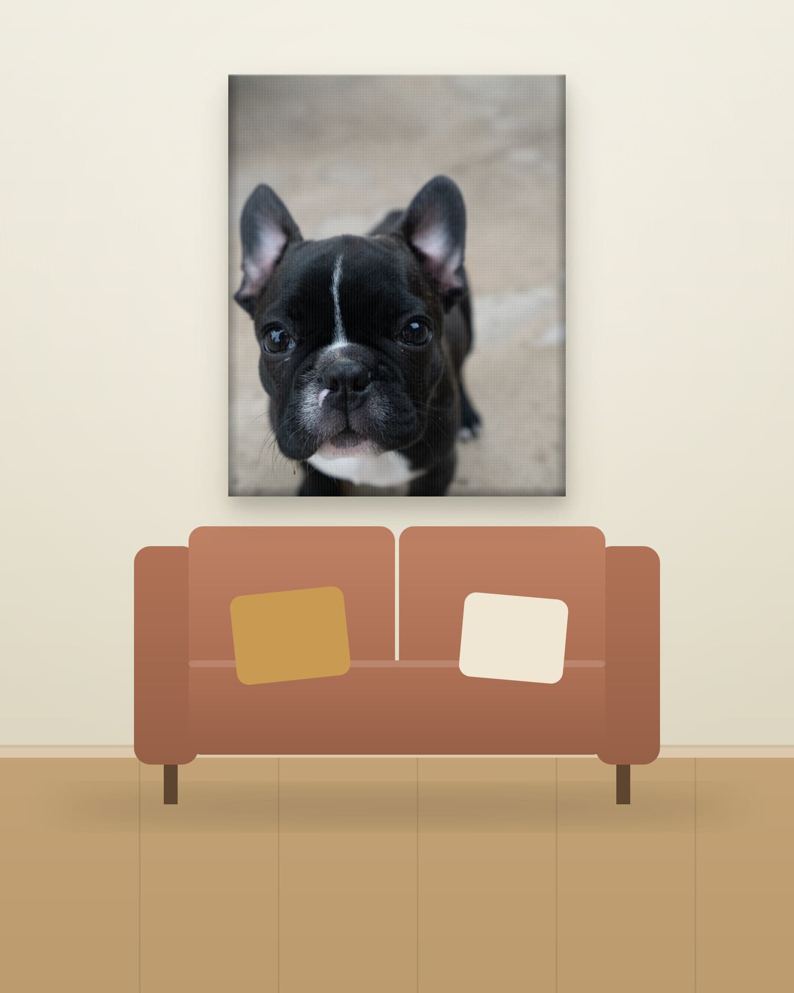 Gallery-wrapped canvas of a black French bulldog puppy, hung above a clay-colored sofa in a modern living room